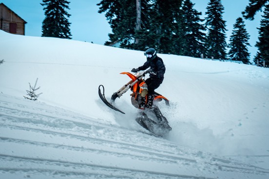 Race across the snow on a mountain kart or moonbike